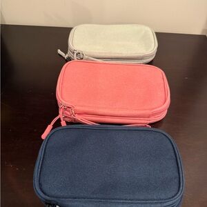 Set of Three Travel Pouches in Coral, Navy, and Light Gray